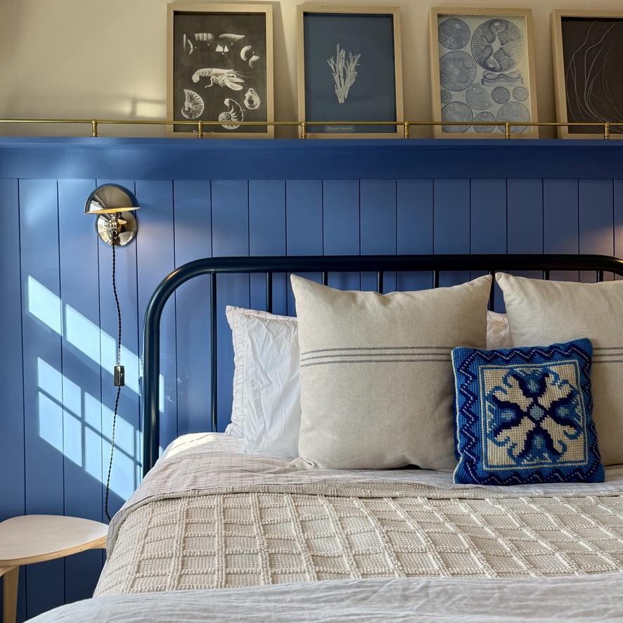 Cape Cod Cottage bedroom with blue tongue-and-groove wall